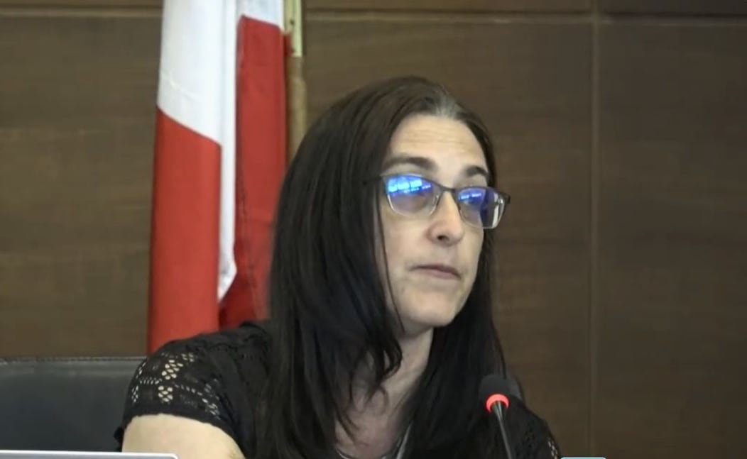 A woman speaks into a microphone.