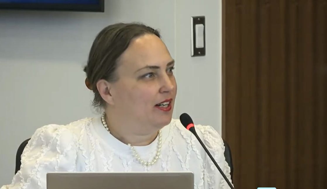 A woman speaks into a microphone.