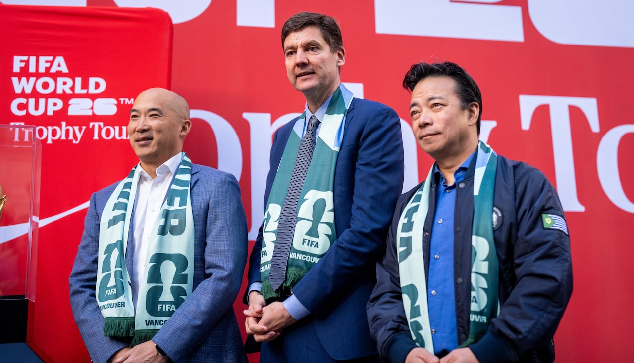 Premier David Eby, center, and Vancouver Mayor Ken Sim, right, are pictured with the original FIFA World Cup trophy during a media event prior to the FIFA World Cup 2026 games in Vancouver, British Columbia, on Friday, Apr. 10, 2026.