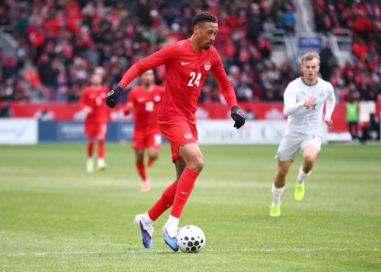 A soccer player handles the ball.