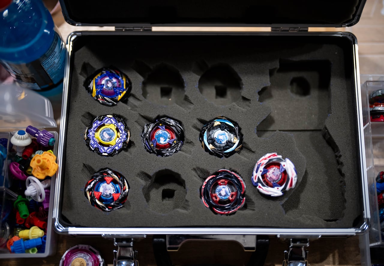 Spinning tops are seen in a case from above.