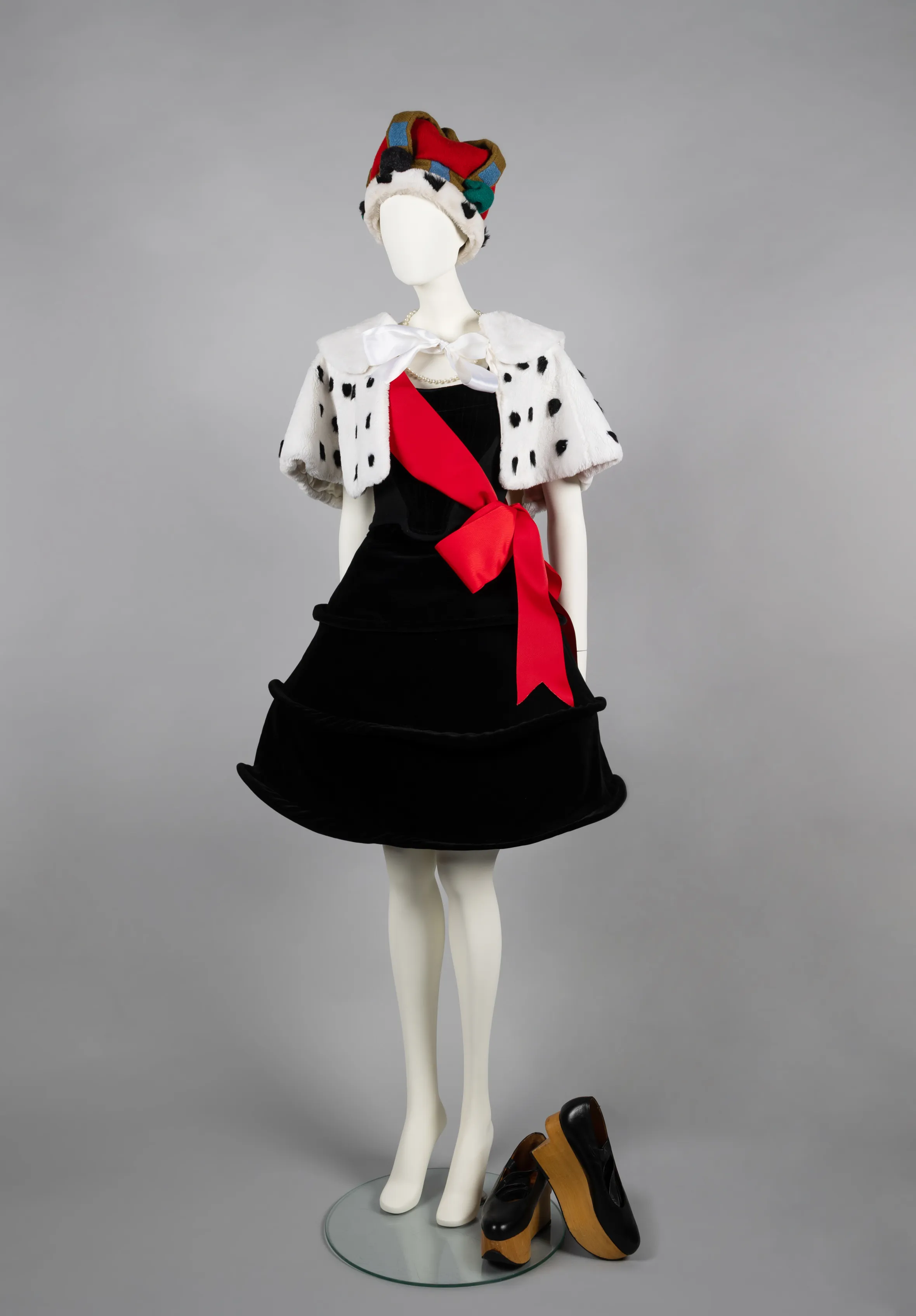 Mannequin wearing a Harris Tweed crown, a faux fur tippet, a Liberty corset, a beehive crinoline, and a grosgrain sash.