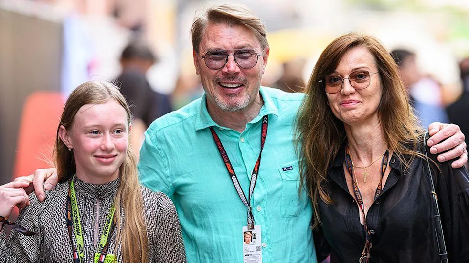 Ella Hakkinen - wearing a grey pattern top, on the left of her father Mika Hakkinen, who is wearing a blue shirt and sunglasses, standing next to wife Marketa Remesova, wearing a black top and sunglasses.