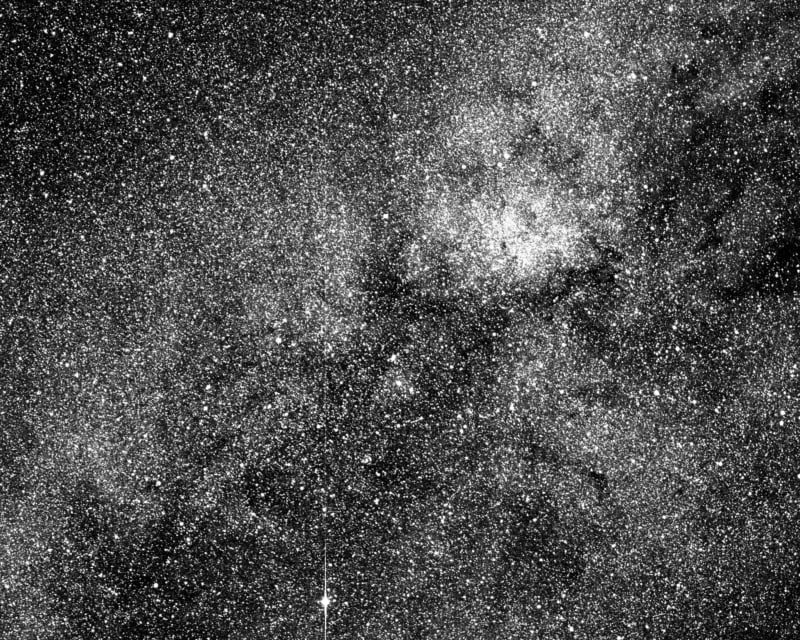 A dense field of countless stars and bright spots against a dark background, resembling the Milky Way or a similar star cluster in deep space.