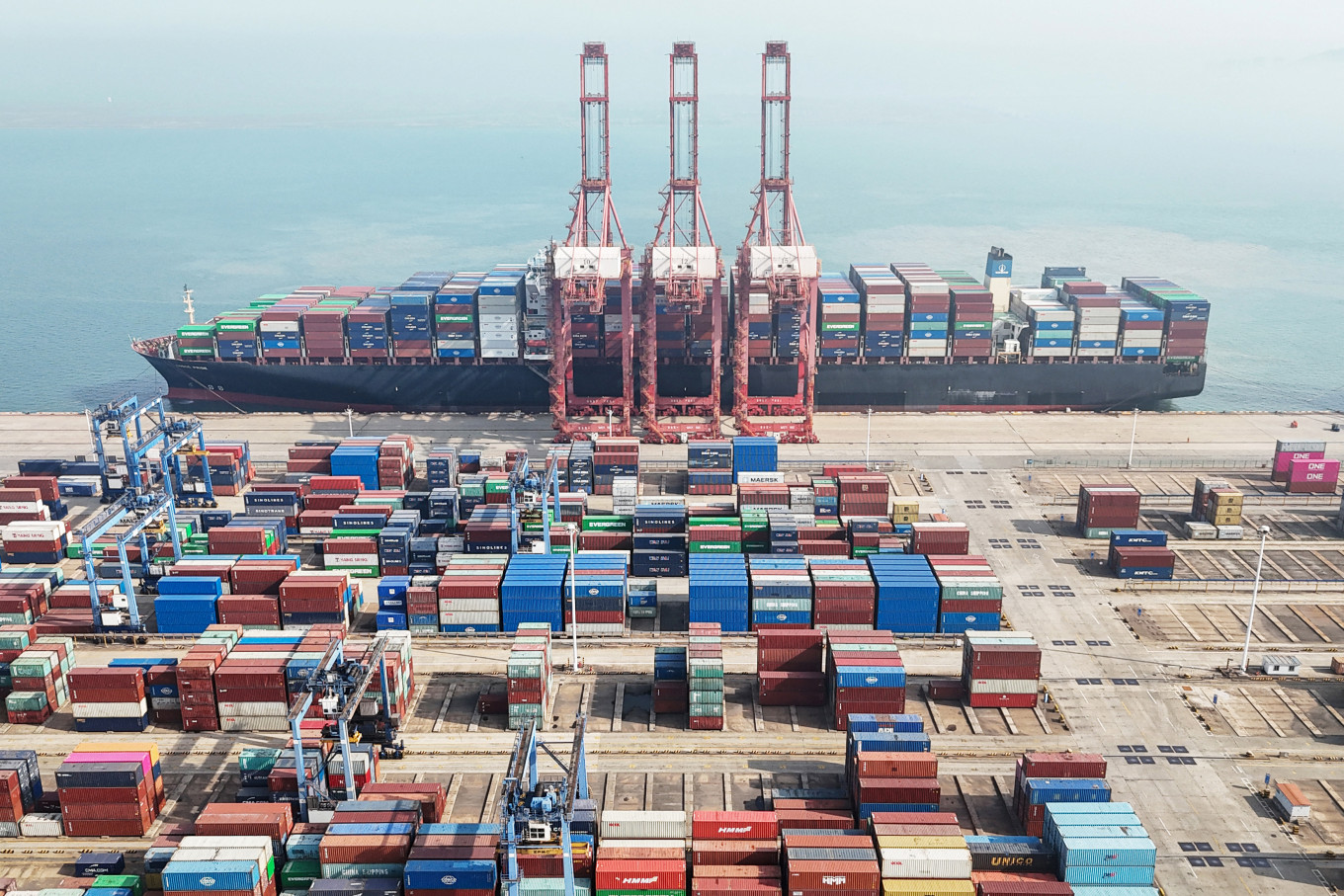 Shipping containers are stacked on April 12, 2024, at a port in Lianyungang, in eastern China's Jiangsu province.