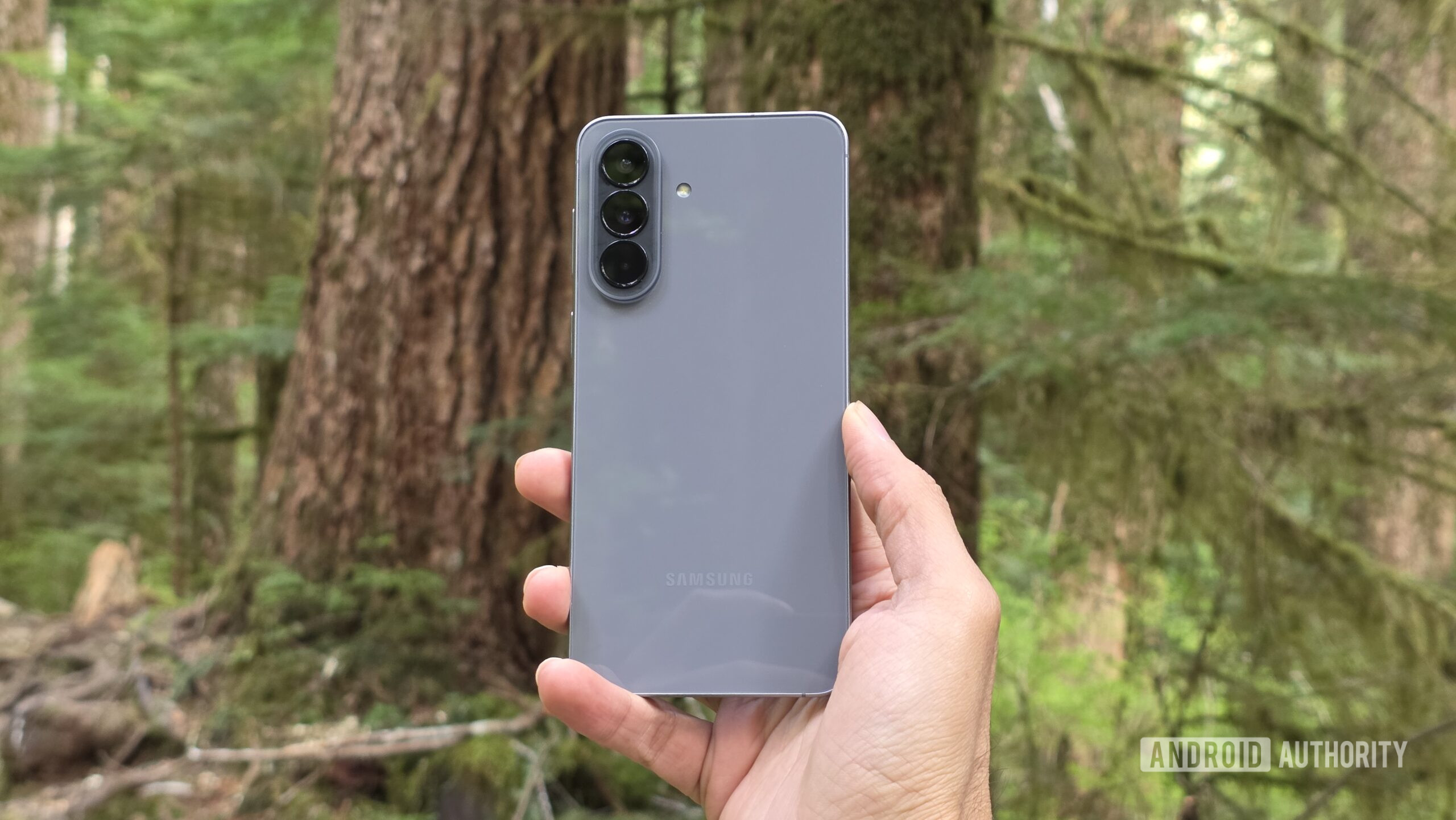 Samsung Galaxy A57 review image 14 Samsung Galaxy A57 review image showing the phone's back in an outdoor setting