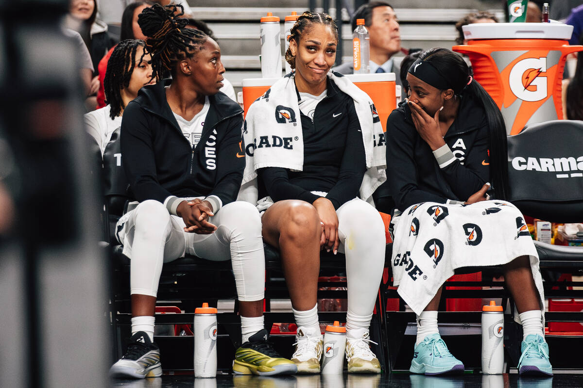 Aces guard Chelsea Gray, center A'ja Wilson and Aces guard Jackie Young (0) talk on the si ...