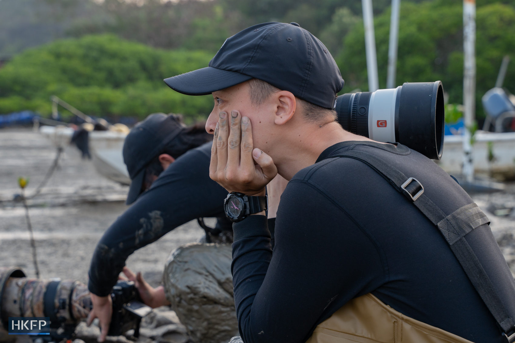 Fung Hon-shing waits to take photos of migratory birds in Yuen Long on March 25, 2026. Photo: Kyle Lam/HKFP.