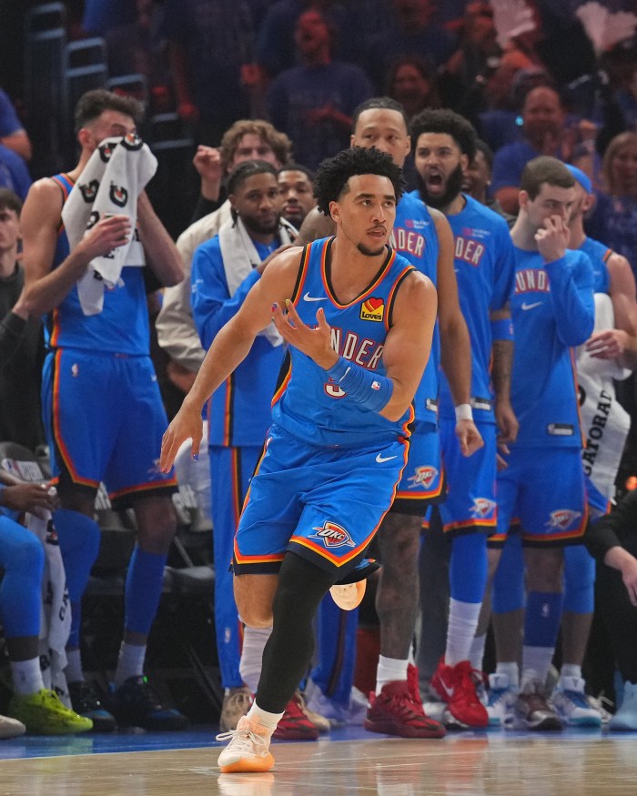 Jared McCain celebrates in front of the Oklahoma City Thunder bench.