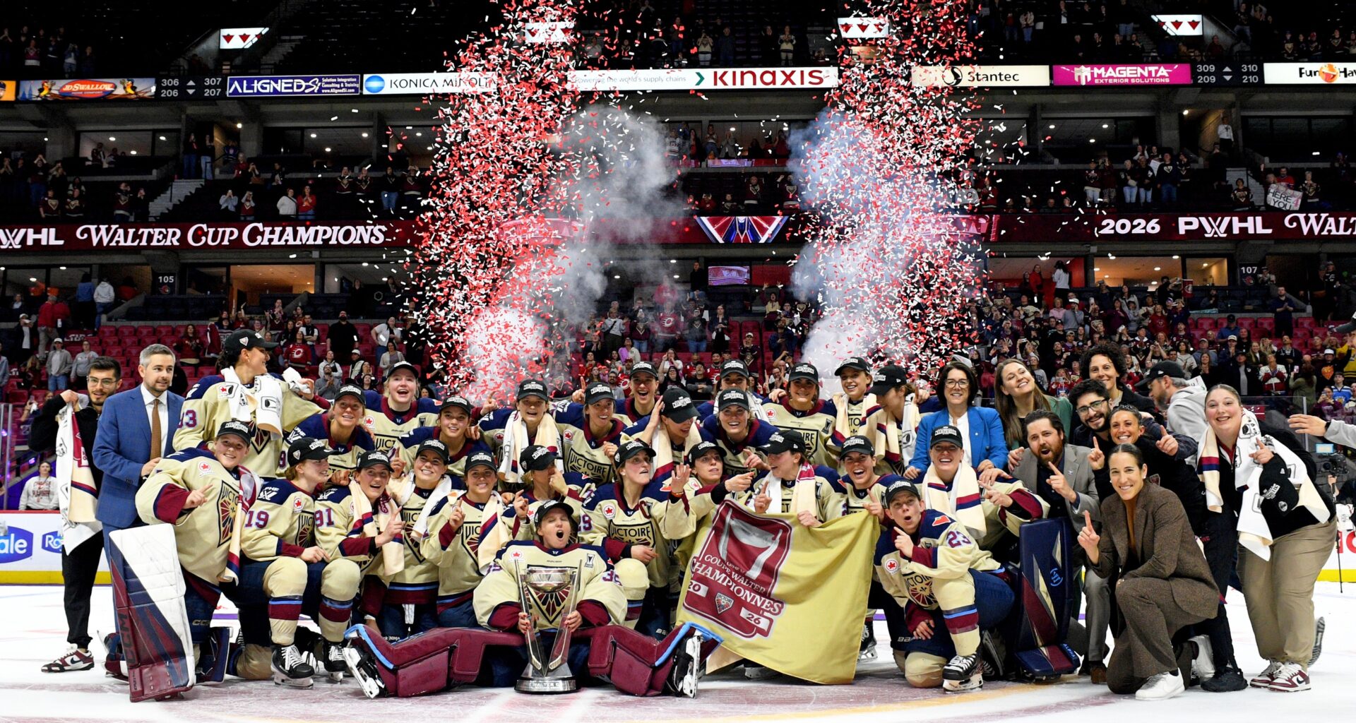 Victoire players pose for a championship photo on the ice.