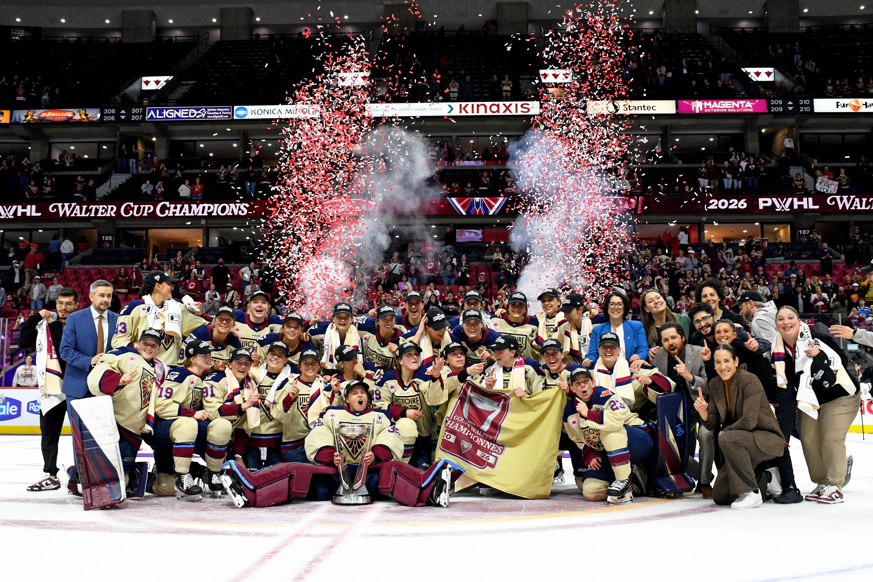 Victoire players pose for a championship photo on the ice.