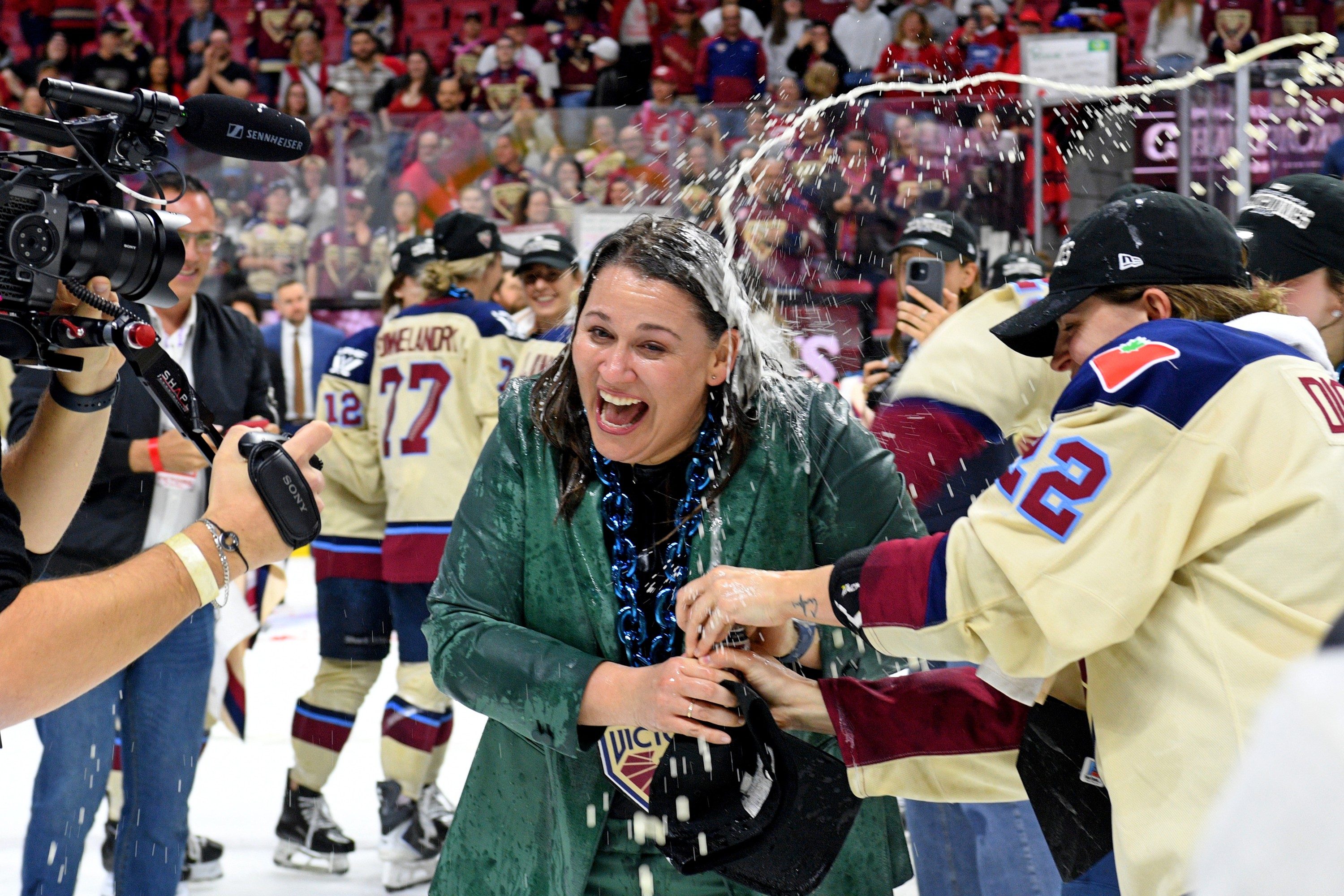 Kori Cheverie reacts after having beer poured on her by celebrating Victoire players.