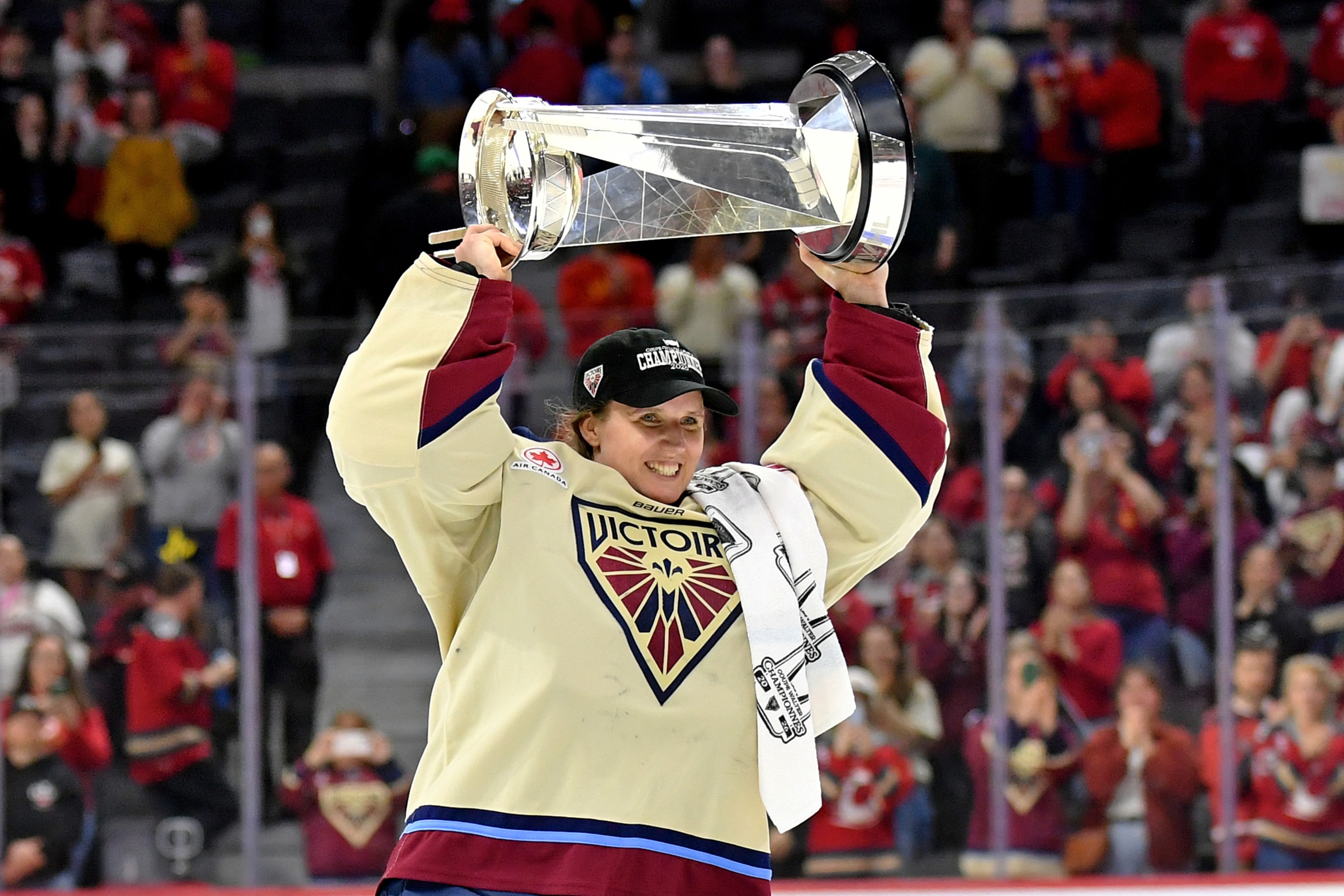 Ann-Renée Desbiens hoists the Walter Cup.