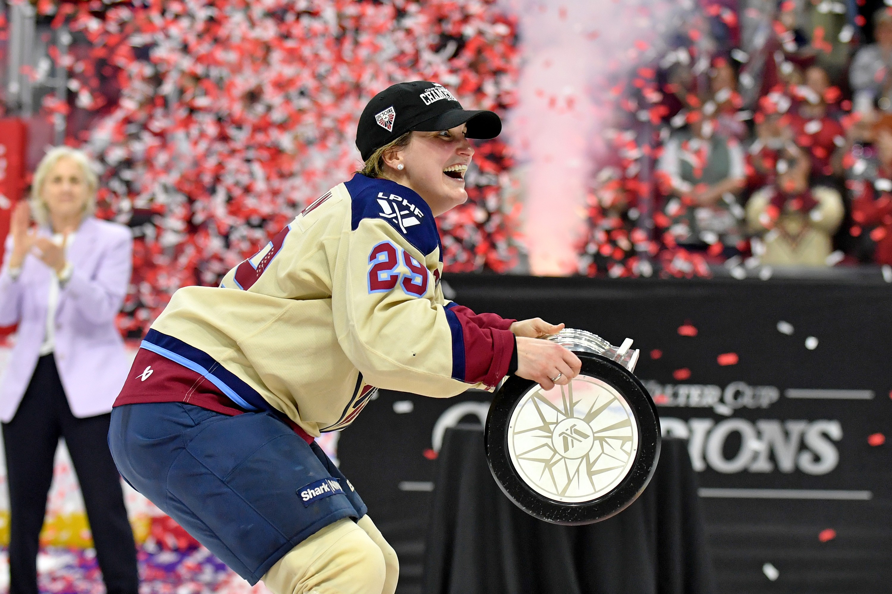 Marie-Philip Poulin prepares to hoist the Walter Cup as confetti pops into the air