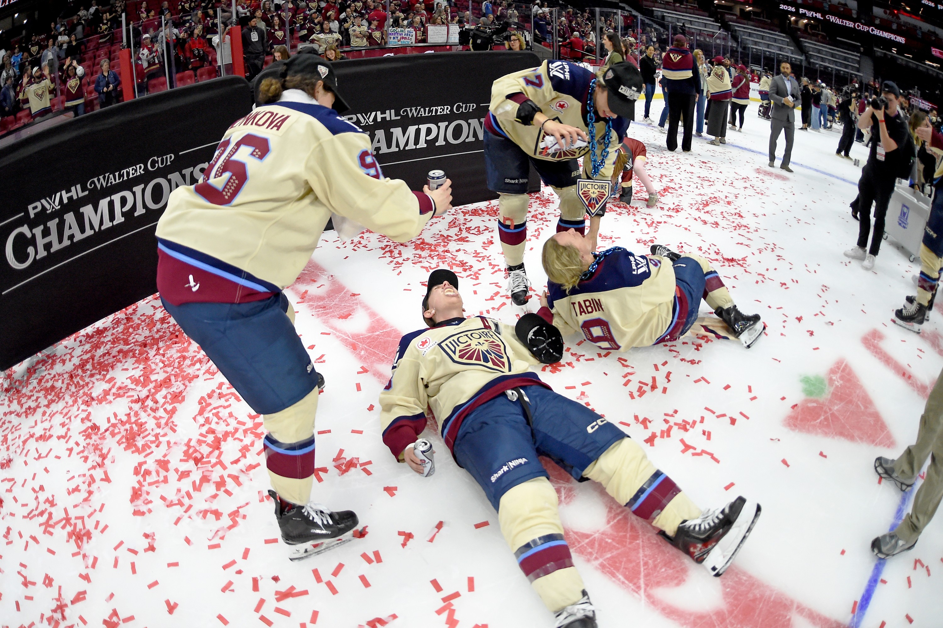 Victoire players pour beer into each other's mouths on the ice.