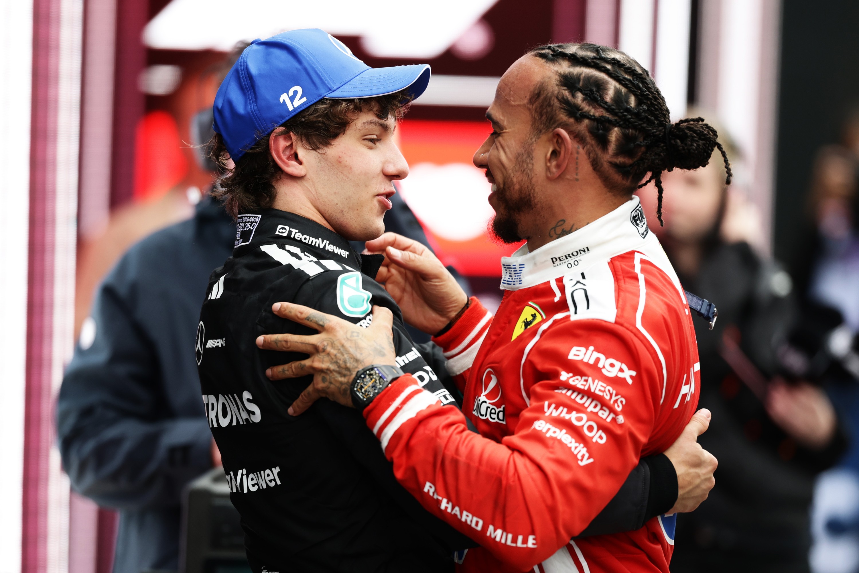 Racers Kimi Antonelli and Lewis Hamilton congratulate each other.