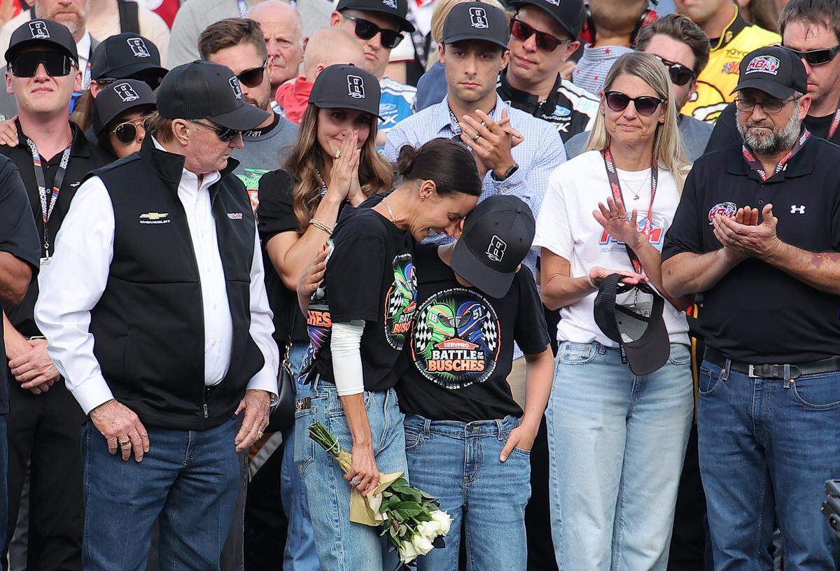 Samantha Busch (wife) and Brexton Busch (son) embrace one another on the grid during the remembrance ceremony for Kyle Busch, who passed away suddenly at the age of 41, prior to the NASCAR Cup Series Coca-Cola 600 at Charlotte Motor Speedway on May 24, 2026 in Concord, North Carolina.