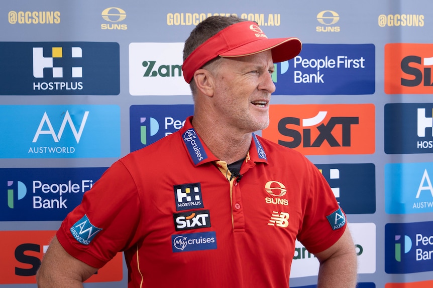AFL coach speaking to media during the day