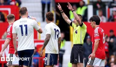Referee Michael Salisbury signals before he awards a second goal to Matheus Cunha of Manchester United after a VAR check