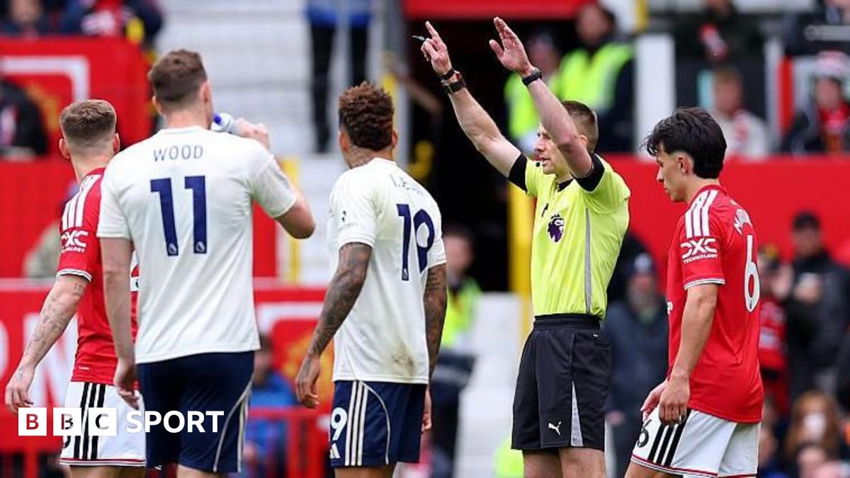 Referee Michael Salisbury signals before he awards a second goal to Matheus Cunha of Manchester United after a VAR check