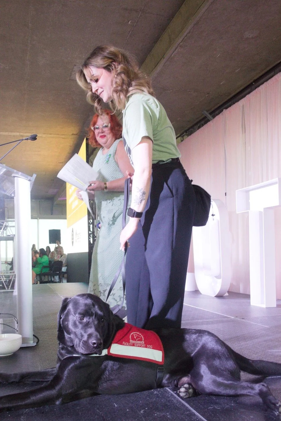Zebra Child and Youth Advocacy Centre CEO Emmy Stuebing, left, introduces Nitro — the centre’s new ‘buddy dog,’ joined by his human Kadin Pochynok.
