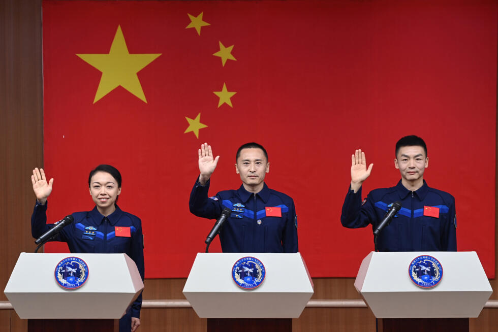 Astronauts for China's Shenzhou-23 space mission Lai Ka-ying (L), Zhu Yangzhu (C) and Zhang Zhiyuan (R) wave during a press conference