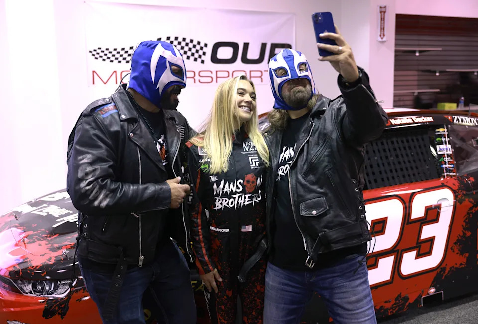 NASCAR Xfinity Series driver Natalie Decker makes an appearance with actors Mike Carey and Chris Margetis in support of "The Manson Brothers Midnight Zombie Massacre."