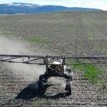 An aerial view of a TerraClear Robot sprayer with a 60 foot boom.