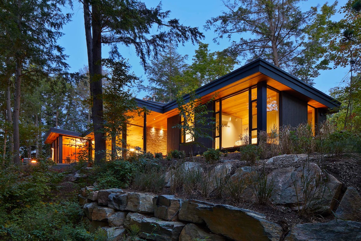 A hidden cottage opens to a shimmering lake