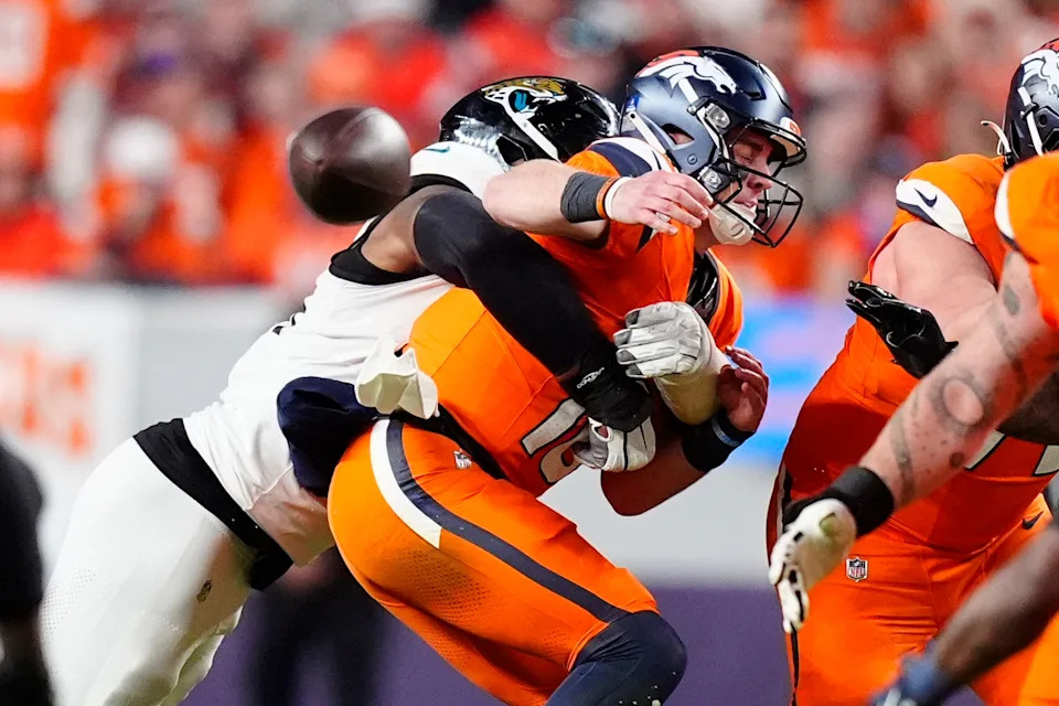 Jacksonville Jaguars defensive end Travon Walker (44) hits Denver Broncos quarterback Bo Nix (10) during the second half at Empower Field at Mile High.