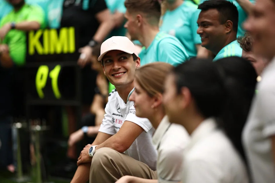 George Russell smiles in the Mercedes team photo after Kimi Antonelli’s victory (Getty Images)