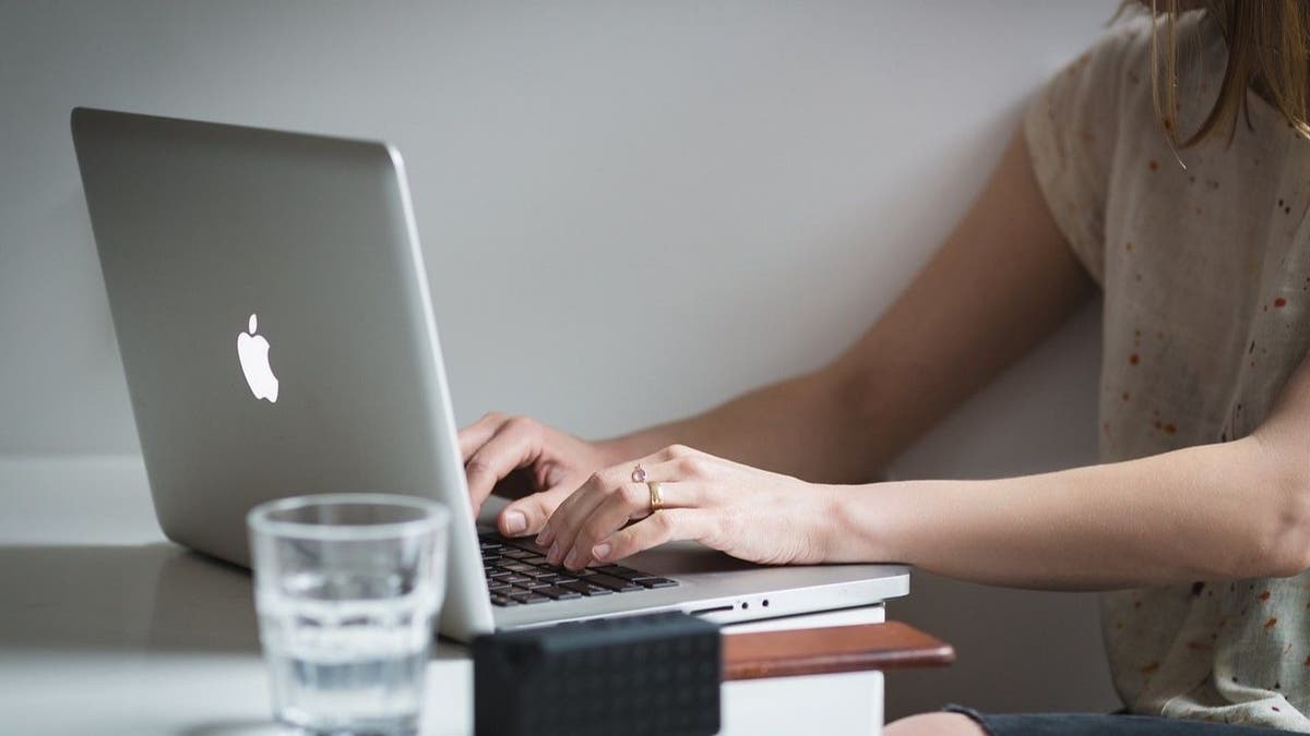 Woman checking retirement accounts on laptop screen