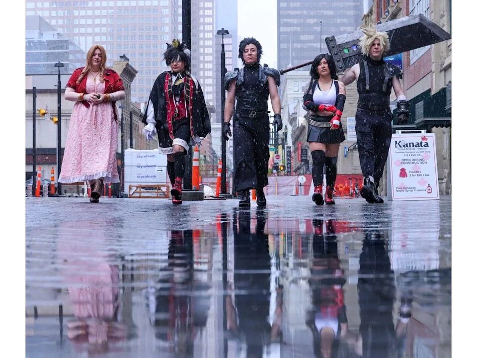 Participants walk through the spring snow towards Otafest, the Japanese anime and pop culture festival, in downtown Calgary on Saturday.