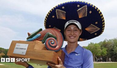 Nelly Korda celebrates winning the Riviera Maya Open in Mexico, wearing a traditional large Mexican hat and blue golf shirt, smiling, and holding a colourful trophy