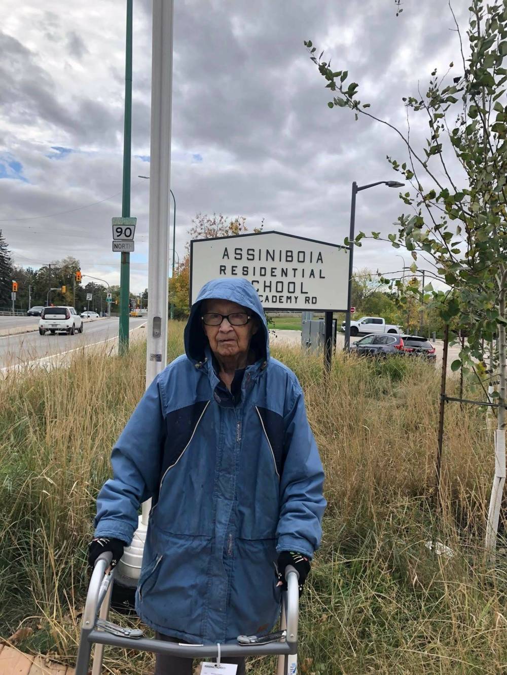 Supplied
Christina Henderson, then 76, stands in front of the sign of the former Assiniboia Residential School, off Academy Road, Sept. 30, 2024.