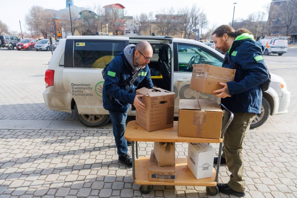 MIKE DEAL / FREE PRESS
Dallas Holden (right) and Bryan Barker collect donations from Tall Grass Prairie Bread Company at The Forks during an early morning patrol.