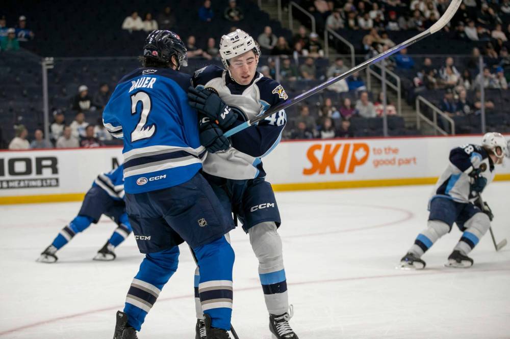 BROOK JONES / FREE PRESS FILES
Manitoba Moose defenceman Tyrel Bauer (2) is known for dropping the gloves, logging 401 penalty minutes in his career with the club.