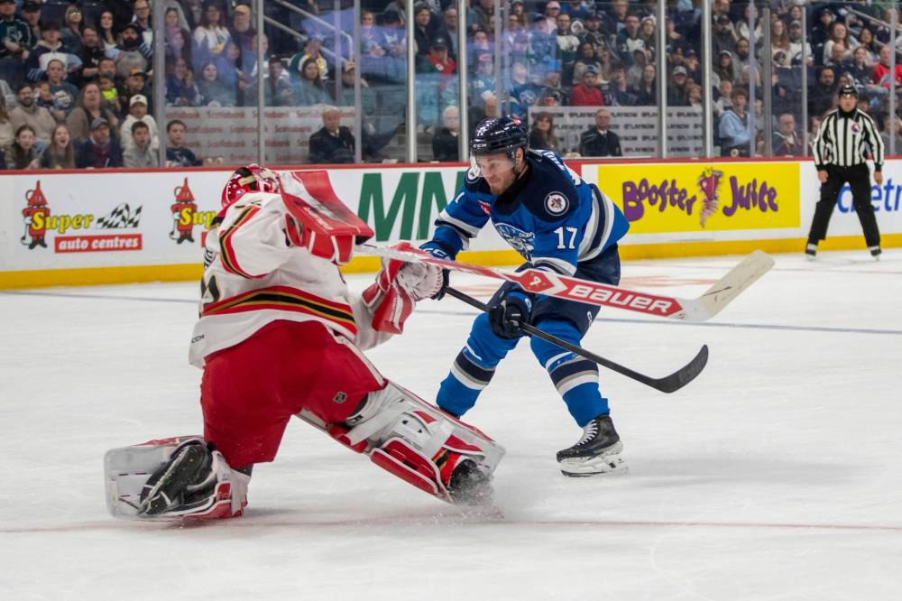 BROOK JONES/FREE PRESS
Manitoba Moose centre Danny Zhilkin is face-to-face with Grand Rapids Griffins goaltender Michal Postava who left his crease to play the puck during second period action Saturday in Winnipeg.