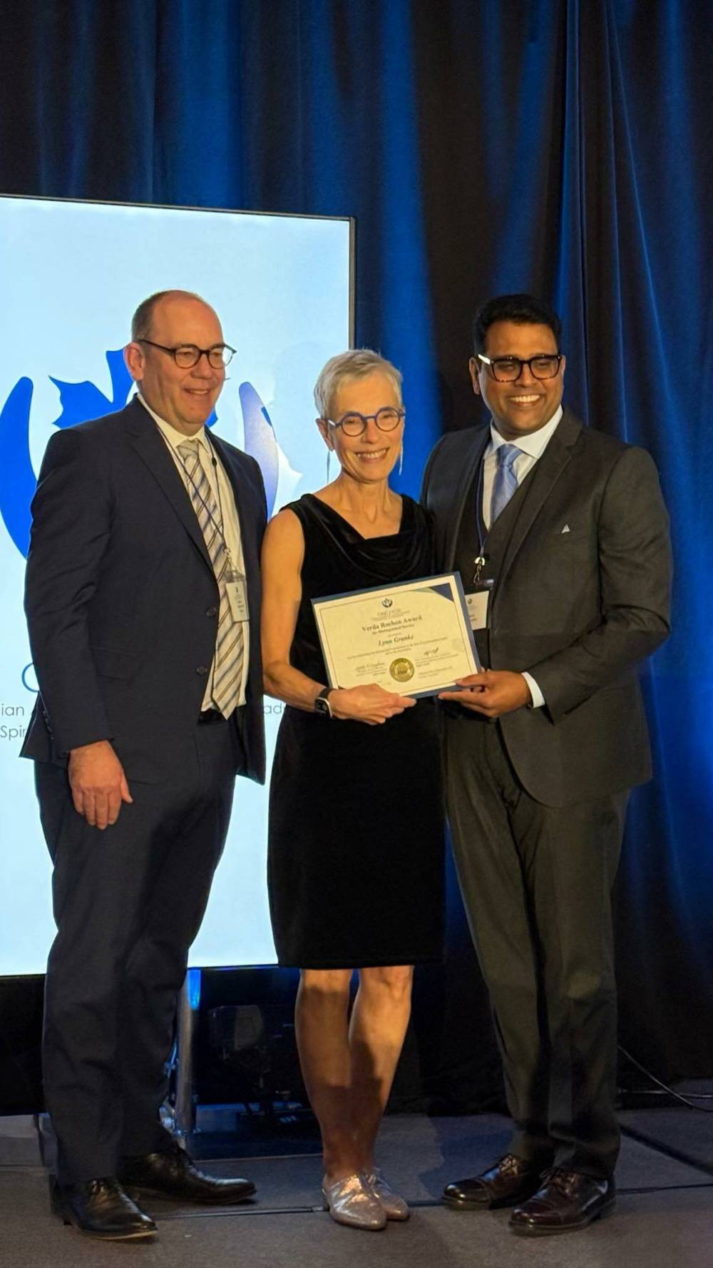 SUPPLIED
Lynn Granke (centre) receives her award from Jeff Chant, CEO of the Canadian Association for Spiritual Care (left), and board president Ajith Varghese.