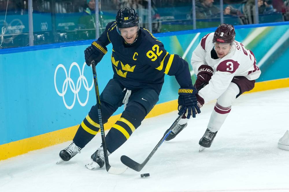 PETR DAVID JOSEK / THE ASSOCIATED PRESS FILES
Latvia’s Alberts Smits (right) challenges Sweden’s Gabriel Landeskog during a men’s ice hockey qualification playoff game at the 2026 Winter Olympics, in Milan, Italy.