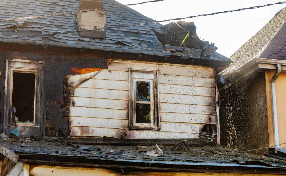 A fire damaged the house at 584 Langside St., seen here, and the house just south of it. (Mike Deal / Free Press)