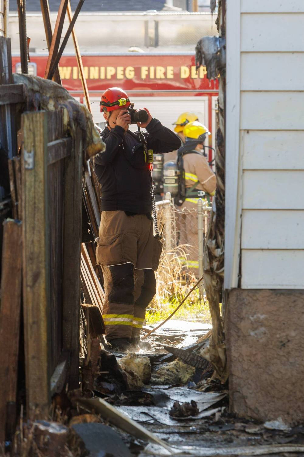 WFPS crews and Winnipeg Police forensic units at the scene of a house fire at 584 Langside St. The fire damaged the house just south of it. (Mike Deal / Free Press)