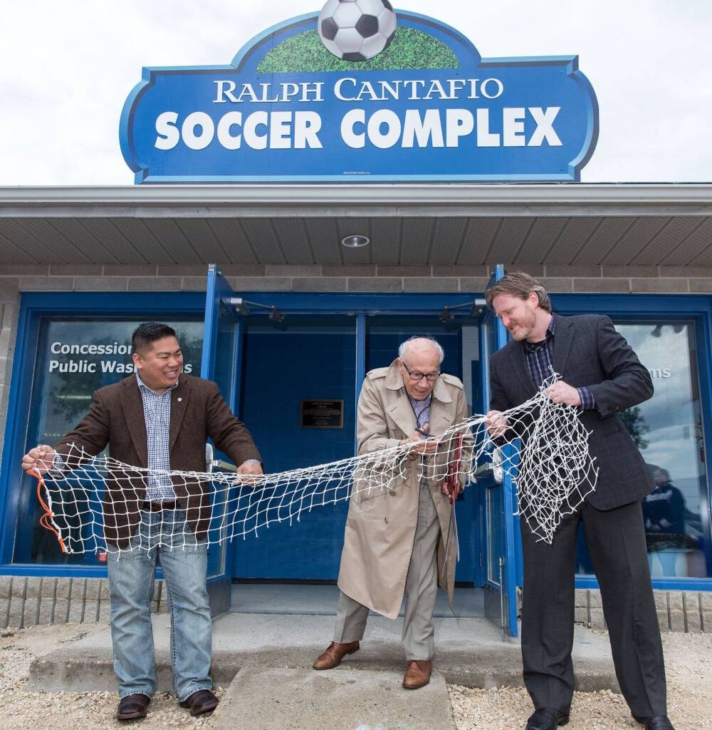 MIKE DEAL / FREE PRESS
                                Cantafio — flanked by then city Coun. Mike Pagtakhan (left) and Matthew Duffy of the 
Winnipeg Soccer Federation — cuts a soccer net on June 12, 2016, to officially change the name of the Winnipeg Waverley Soccer Complex to the Ralph Cantafio Soccer Complex.