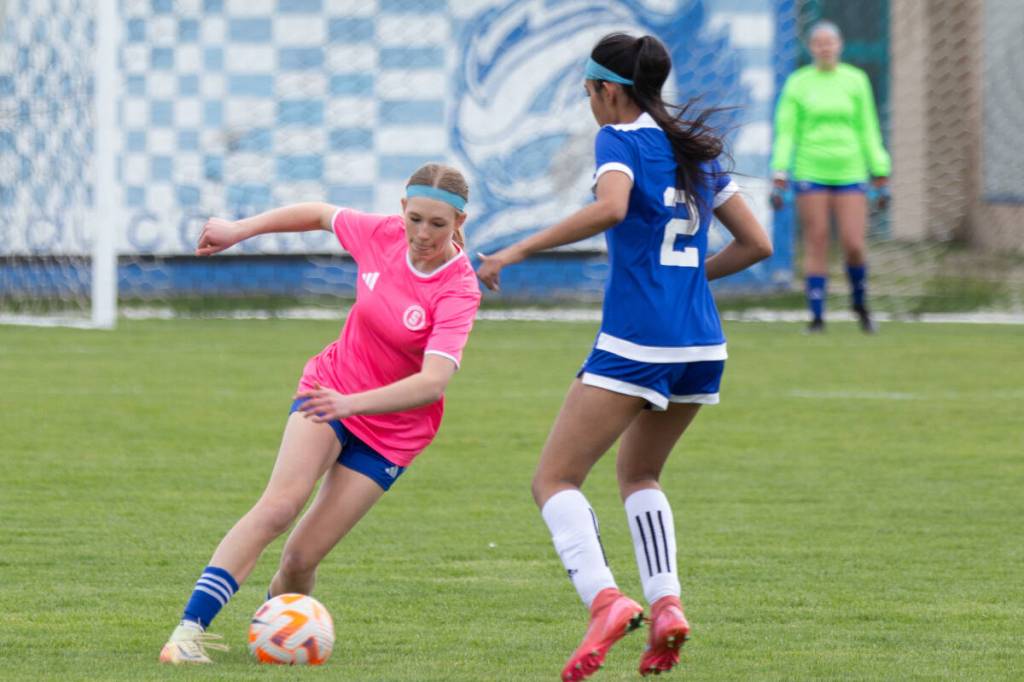 Maddie Waldegger of the Seaton Sonics (left) dribbles around a Queen Elizabeth Royals defender from Surrey during action at the Okanagan Classic Senior Girls High School Soccer Tournament April 23-24 in Vernon. (Laurie Stinn Photo)