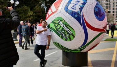 A fan snaps a photo alongside a giant soccer ball display outside the B.C. legislature during the Canada Celebrates test event on Tuesday. (Tony Trozzo/Victoria News)