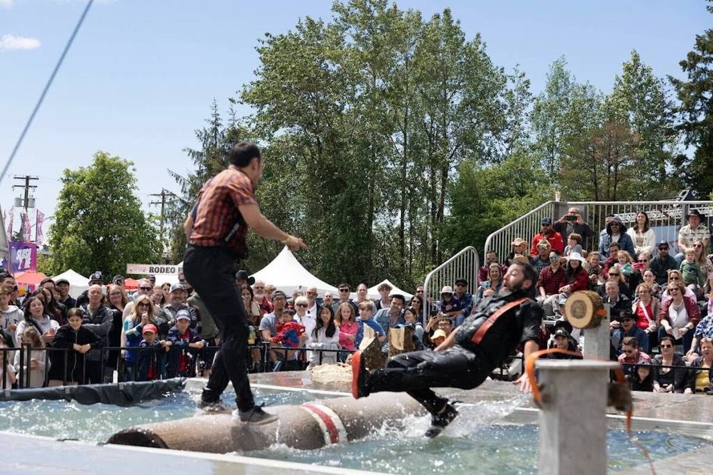 A log-roller is about to hit the drink during a West Coast Lumberjack Show competition at a previous Cloverdale Country Fair. The ever-popular lumberjack show is back for the 2026 fair. (Photo: Jason Sveinson)