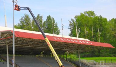 Workers fix up the lights near the grandstand in the Stetson Bowl ahead of the 2026 Cloverdale Rodeo and Country Fair. (Photo: Malin Jordan/Cloverdale Reporter)