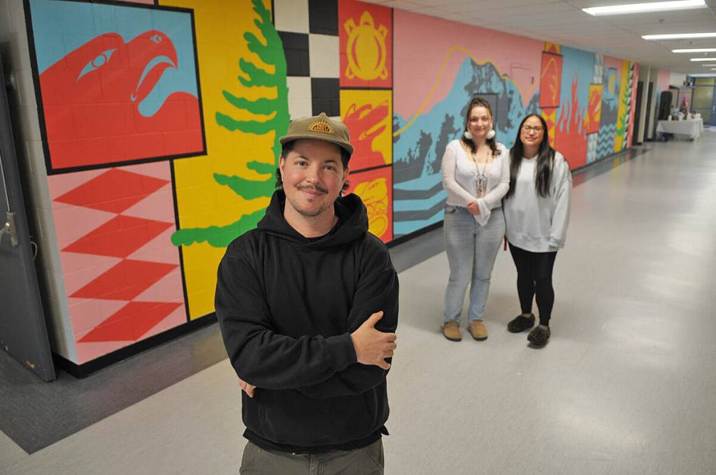 Artist Josh Conrad, seen here with Indigenous support workers Caitlin Demmitt and Kristie Peters, painted this mural inside Shxwelis te Ts&rsquo;qó:ls (Spirit of Hope Secondary School). They are pictured on April 10, 2026. (Jenna Hauck/ Hope Standard)