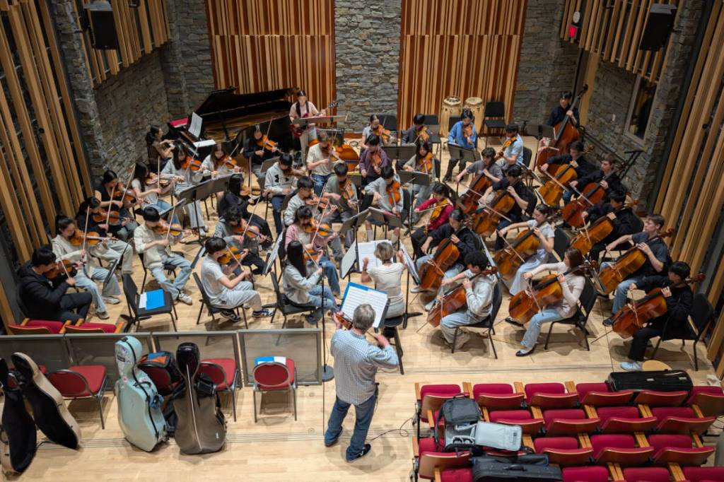 Violin soloist Cameron Wilson rehearses Suite Francaise – a tribute to three famed French jazz violinists – with String Studies director Carla Birston and the Sinfonietta ensemble at the VSO School in Vancouver. (Contributed to Peace Arch News))