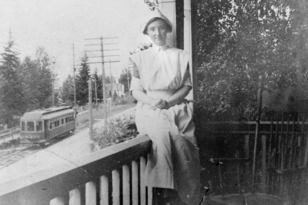 Unknown nurse on the verandah of the Home Hospital (1902–1909), overlooking the streetcar route on Front Street. This could be a photo of Ella DesBrisay, Ethel Ferris, or Ira Morris. DesBrisay and Ferris opened the Home Hospital on July 31, 1902, and several years later Ira Morris joined DesBrisay in running the hospital after Ethel Ferris&rsquo;s marriage. (Nelson Museum, Archives and Gallery)